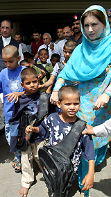 Pakistani children who were used as camel jockeys arrive at Lahore airport on Tuesday
