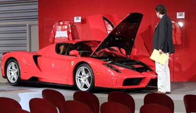 A man looks at the 400th Ferrari Enzo on display as a part of a collection of dream cars and memorabilia to be sold at the legendary home of Ferrari in Maranello, Italy.