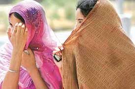 Two young girls beat the relentless heat by covering their faces in the city on Wednesday