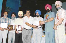 The Minister for Animal Husbandry and Dairy Development, Mr Jagmohan Singh Kang, presents awards at a function held in Ludhiana