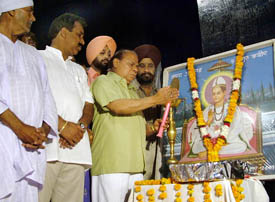 Mr Jagjit Singh, Minister of Local Bodies, lights a candle at the 607th birth anniversary function of Bhagat Kabir in Jalandhar on Wednesday.