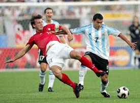 Germanys Bernd Schneider challenges Argentinas Carlos Tevez during their Confederations Cup Group A soccer match in Nuremberg