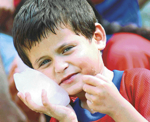 A piece of ice is all that a kid needs to keep himself cool on a hot, humid day in Chandigarh. 