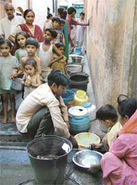 Residents of Uchi Khangah Colony in Garha queue up to have their precious fill, as water trickles down the tap