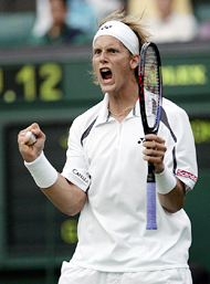 Joachim Johansson of Sweden celebrates after defeating Greg Rusedski of Great Britain in the second round of Wimbledon on Wednesday