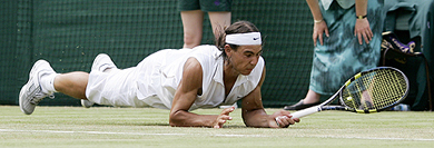 Spain's Rafael Nadal dives to return the ball to Luxembourg's Gilles Muller