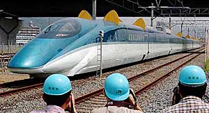 Japans newest model of Shinkansen bullet train is unveiled for the media at its test centre at Rifu, northern Japan, on Friday. East Japan Railway Co., which is developing a new-generation model, displayed two types of the jade-colour trains, with different shapes of its nose. The operator hopes to cruise the new train at a speed of 360 km per hour, believed to be the worlds fastest.