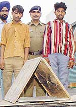 Vijay Kumar and Peer Mohammad with the stolen manhole covers in Chandigarh