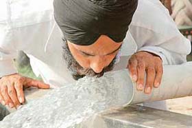 A Ludhiana resident quenches his thirst by gulping down gushing water