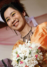 A Myanmar model presents a wedding outfit at a fashion show during the Wedding Fair, 2005, in Yangon on Saturday.