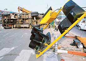 A truck rams into traffic lights, pulling them down before overturning, near the Housing Board crossing in Chandigarh on Saturday