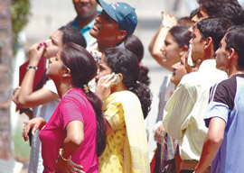 Anxious candidates scan a cut-off list displayed in a Delhi University college in the Capital on Saturday.
