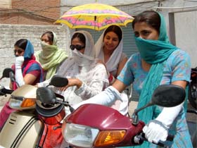 College girls cover their faces and arms before moving out as mercury soared to over 45C in Bathinda