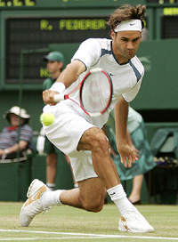 Roger Federer of Switzerland plays a backhand return during his match against Nicolas Kiefer of Germany in the third round at Wimbledon on Saturday
