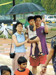 A tourist couple enjoying the drizzle on Rajpath in the Capital on Sunday.