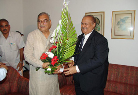 Haryana Chief Minister Bhupinder Singh Hooda presented a bouquet by Mr P.K. Tayal, Chairman of Rajasthan Bank, in Mumbai on Sunday