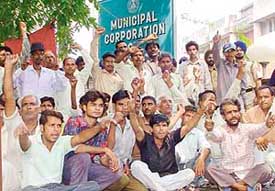 Members of the cycle workers union protest outside the Municipal Corporation office in Sector 17 of Chandigarh 