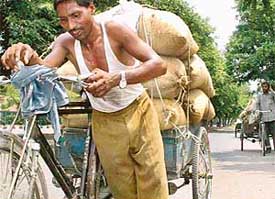 A man appears breathless, pulling an overloaded cart on a sultry Monday in Chandigarh