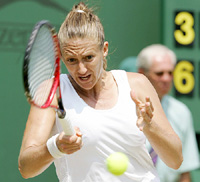 Mary Pierce of France returns the ball to Italys Flavia Pennetta in their womens singles fourth round match at Wimbledon on Monday