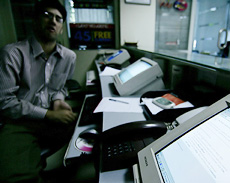 A Pakistani sits next to computers at his office in Islamabad on Tuesday.