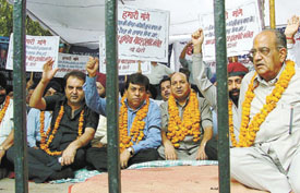 Transporters sitting on dharna under the banner of All India Motor Transport Congress to demand rollback of the recent hike in diesel price and withdrawal of toll tax from all roads in the Capital on Tuesday. 