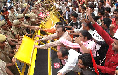 Activists of Left parties push barriers as the police tries to stop them during a protest in New Delhi on Tuesday.