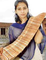 Parampreet Kaur displays her Rs 10 collection in Ludhiana.