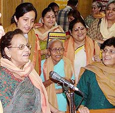 Some of the women from India (from left) Shiela Deedi from Chandigarh, Dilafroj Kazi from J&K, Sharda Krishna, Maninder Meenu and Abha Di (all for Delhi) who have been nominated for the 2005 Nobel Peace Prize, sing a song for their unity at a function in New Delhi on Wednesday. 