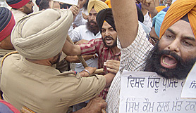 Police personnel try to control activists of the Sikh Students Federation (Mehta) who held a protest in Amritsar on Wednesday. 