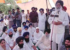 SAD President Parkash Singh Badal addresses a gathering during a dharna against the Amarinder Singh government in Jalandhar on Wednesday.