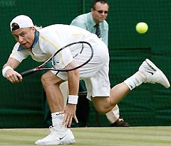 Lleyton Hewitt of Australia returns the ball to Feliciano Lopez of Spain during their quarterfinal match at Wimbledon on Wednesday