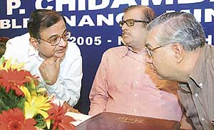 Finance Minister P. Chidambaram with Revenue Secretary K. M. Chandrashekhar and Adviser to Finance Minister Parthasarathy Shome at the launch of a help centre for small taxpayers in New Delhi on Thursday
