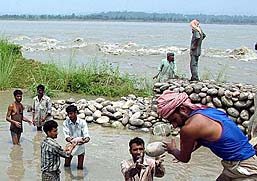 Residents of Narsinghpura village, about 40 km from Jammu, build a bundh as a precaution against the rising water level of the Chenab on Thursday.