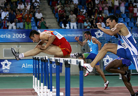 Felipe Vivancos of Spain runs ahead of Andrea Giaconi of Italy and Juraj Grabusic of Croatia in the mens 110m hurdles final at the 15th Mediterranean Games in Almeria, Spain, on Wednesday