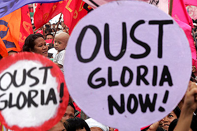 Hundreds of protesters call for the resignation of the Philippine President Gloria Macapagal Arroyo in front of a Catholic Church in Manila on Thursday