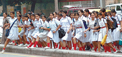 Schoolchildren going to school after their summer vacation on Friday.
