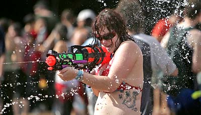 A woman plays with a toy water gun during a water festival in Tel Aviv on Friday