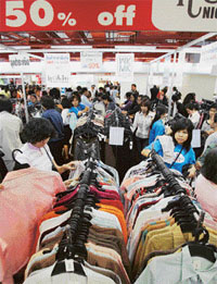 Shoppers rush to readymade garment stalls to take advantage of the mid-year sale in Bangkok on Saturday. High oil prices pushed up inflation in Thailand to 3.8 per cent last month. The June consumer price index, based on a basket of 373 goods, was 0.3 points higher than in May.