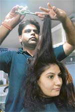 A hair-stylist works on the tresses of a damsel in Chandigarh.