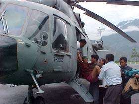 A patient being helped to board a chopper at Pooh