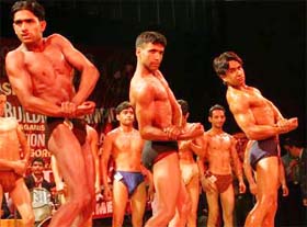 Body builders line up during the Mr Kashmir competition in Srinagar