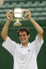 Frances Jeremy Chardy lifts the trophy for boys singles at Wimbledon on Saturday