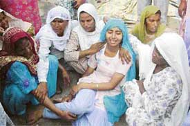 Wailing relatives of the deceased in Mukhandpur village