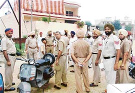 Policemen stand guard during a religious body’s protest against a ‘dera’ in Moga on Sunday.