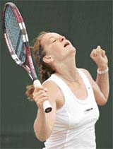 Polands Agnieszka Radwanska celebrates after winning the girls singles final against Austrias Tamira Paszek at Wimbledon in London on Saturday