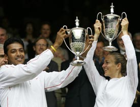 Indias Mahesh Bhupathi and Mary Pierce of France hold the mixed doubles winners trophies at Wimbledon