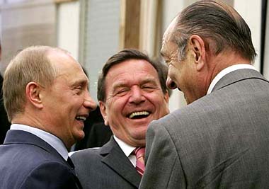 Russian President Vladimir Putin, German Chancellor Gerhard Schroeder and French President Jacques Chirac laugh as they pose for a picture in Svetlogorsk, 40 km from Kaliningrad, on Sunday