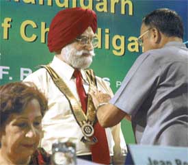 The Punjab Governor and UT Administrator, Gen S.F. Rodrigues (retd), installs the president of the Rotary Club, Chandigarh, on Monday