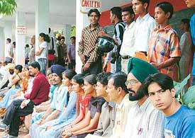 Anxious parents and students await their turn for admission outside GMSSS-23 in Chandigarh. Centralised admissions to Class XI began in government schools