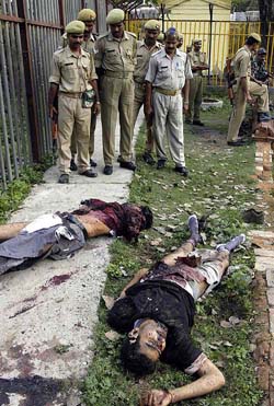 Police personnel inspect the bodies of two of the six terrorists who were shot by security forces when they attempted to enter the makeshift Ram temple in Ayodhya on Tuesday. 